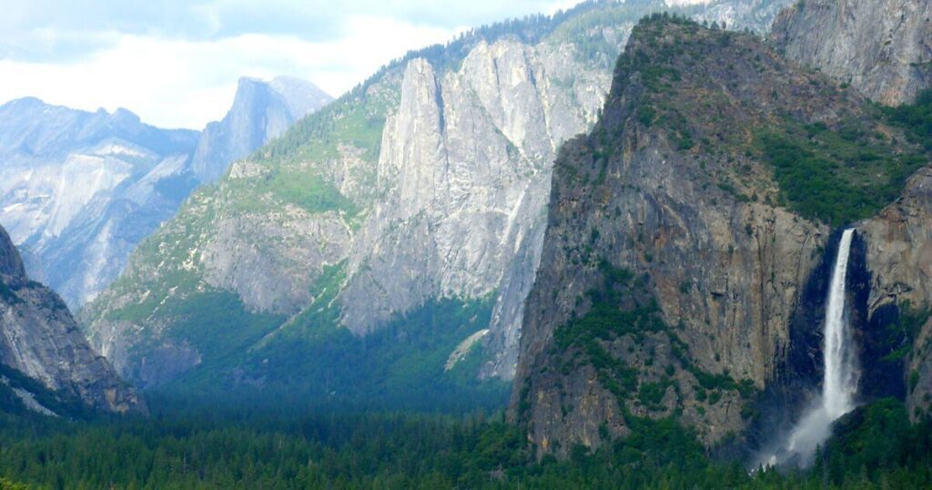 Landscape shot of Bridalveil Fall in Yosemite National Park, with Yosemite Valley and mountains