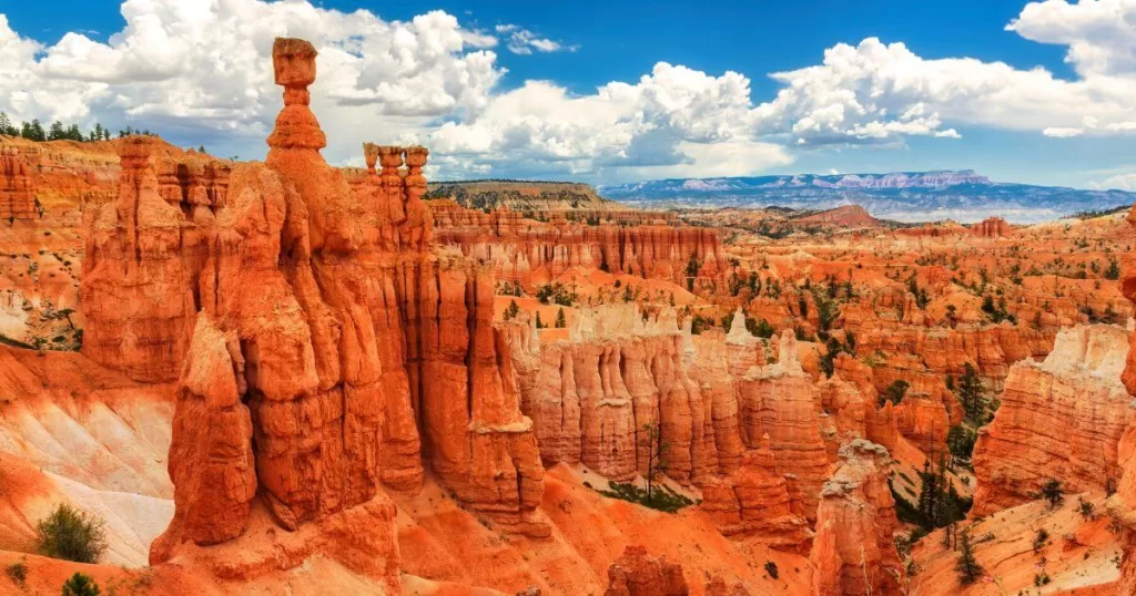 Great spires carved away by erosion in Bryce Canyon National Park, Utah. Blue sky and clouds in the background