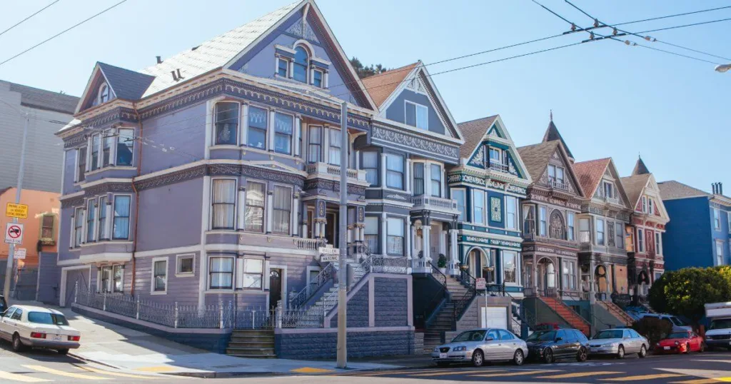 Victorian houses line the streets of Haight-Ashbury in San Francisco, showcasing intricate architectural details and a variety of vibrant colors, a signature of the historic neighborhood.