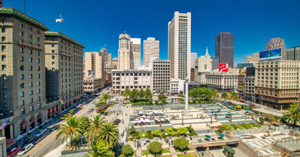 Union Square in San Francisco, a bustling plaza surrounded by tall buildings and busy streets, is a vibrant hub for shopping and socializing, an essential experience for visitors looking for things to do in San Francisco.